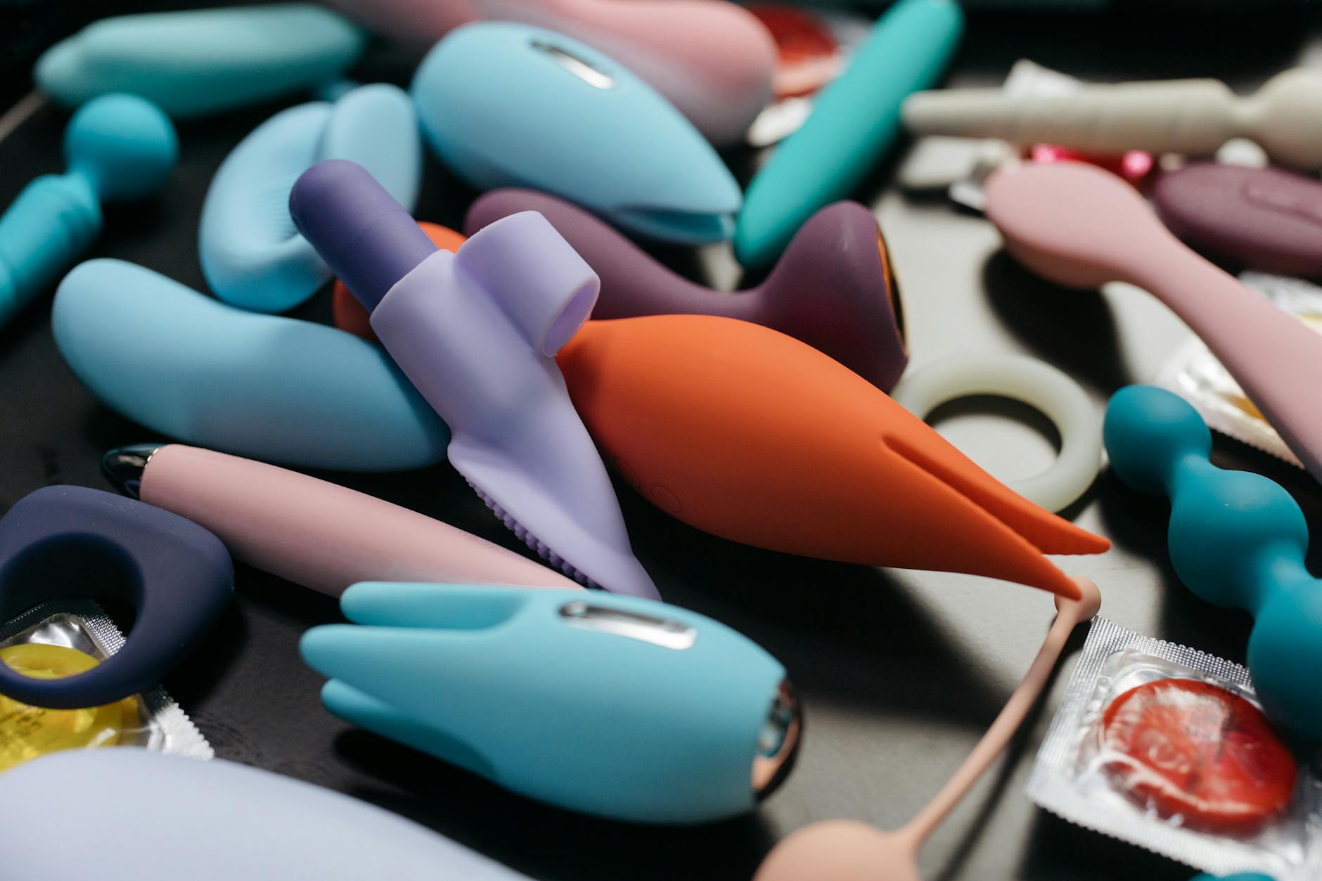 Close-up of hands holding a sleek vibrator, representing reconnection with pleasure after medication adjustment