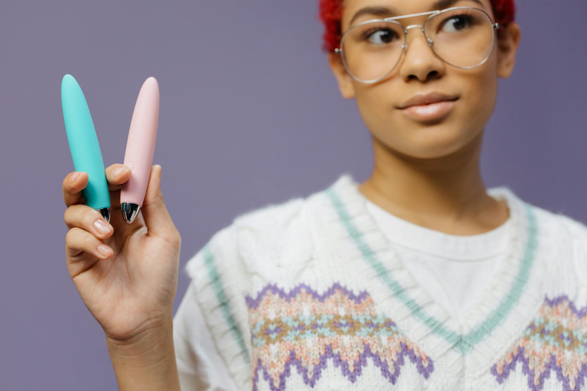 Woman holding two vibrators, representing discreet pleasure options
