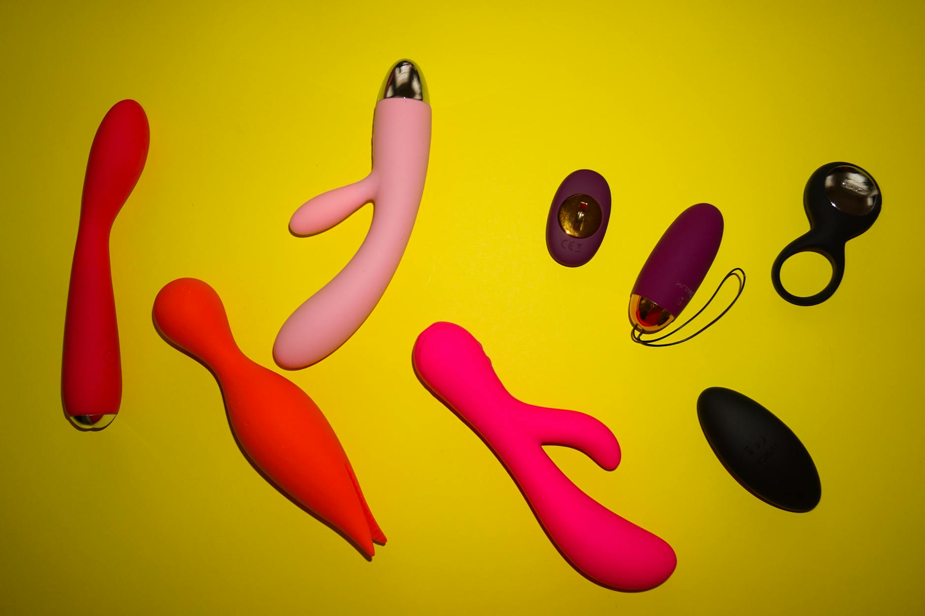 Close-up of hands holding a sleek blue vibrator against a purple background, symbolizing intimate connection and shared pleasure