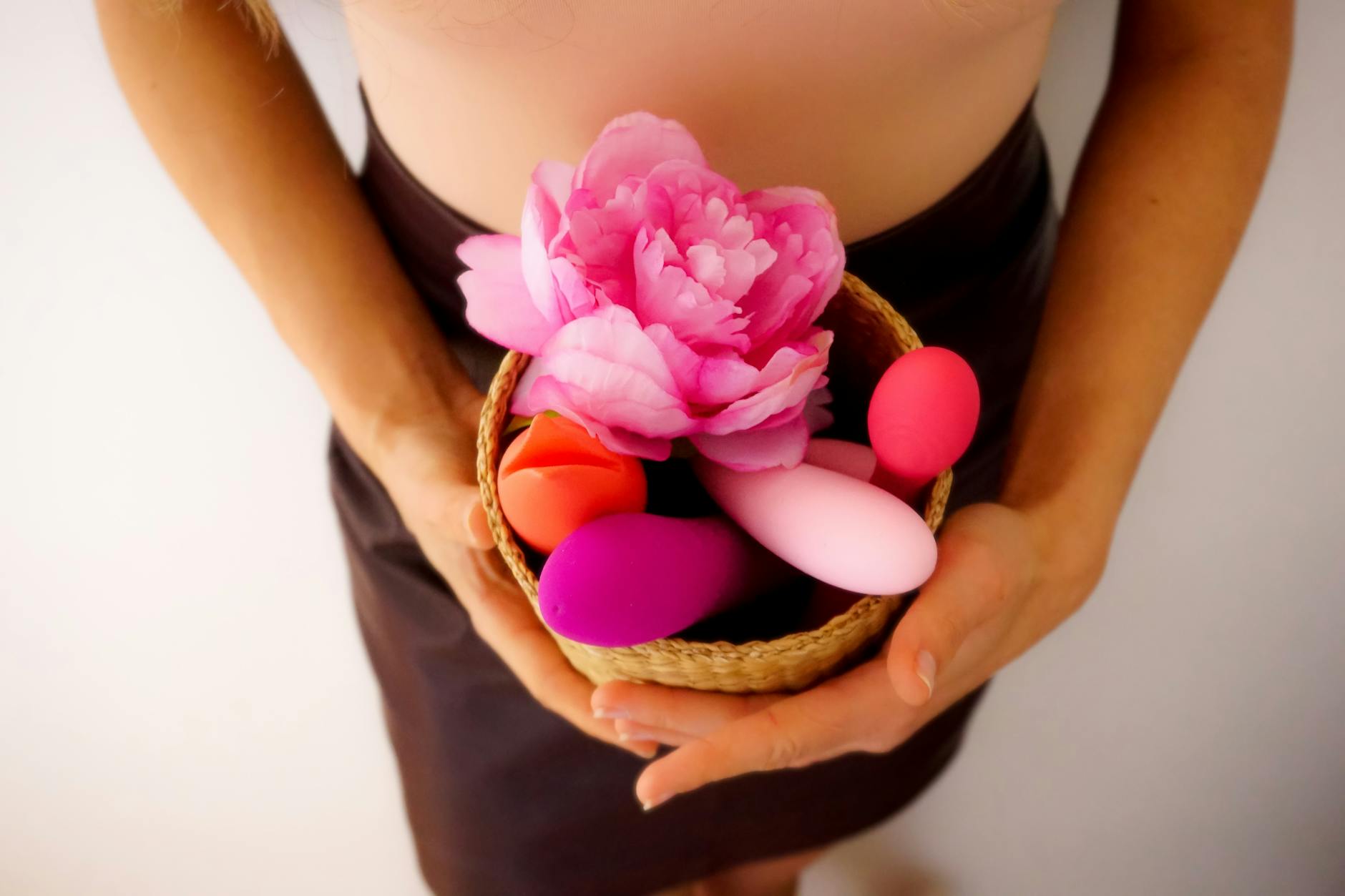 A blue silicone sex toy held in hand against a purple background, promoting self-love and sexuality